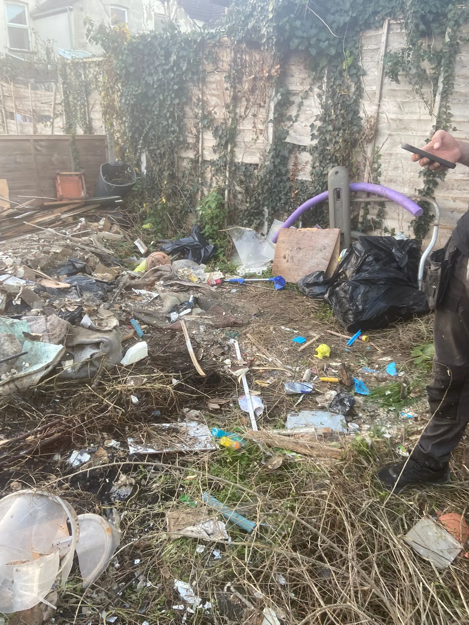 Clearance team part-way through loading a garden waste job