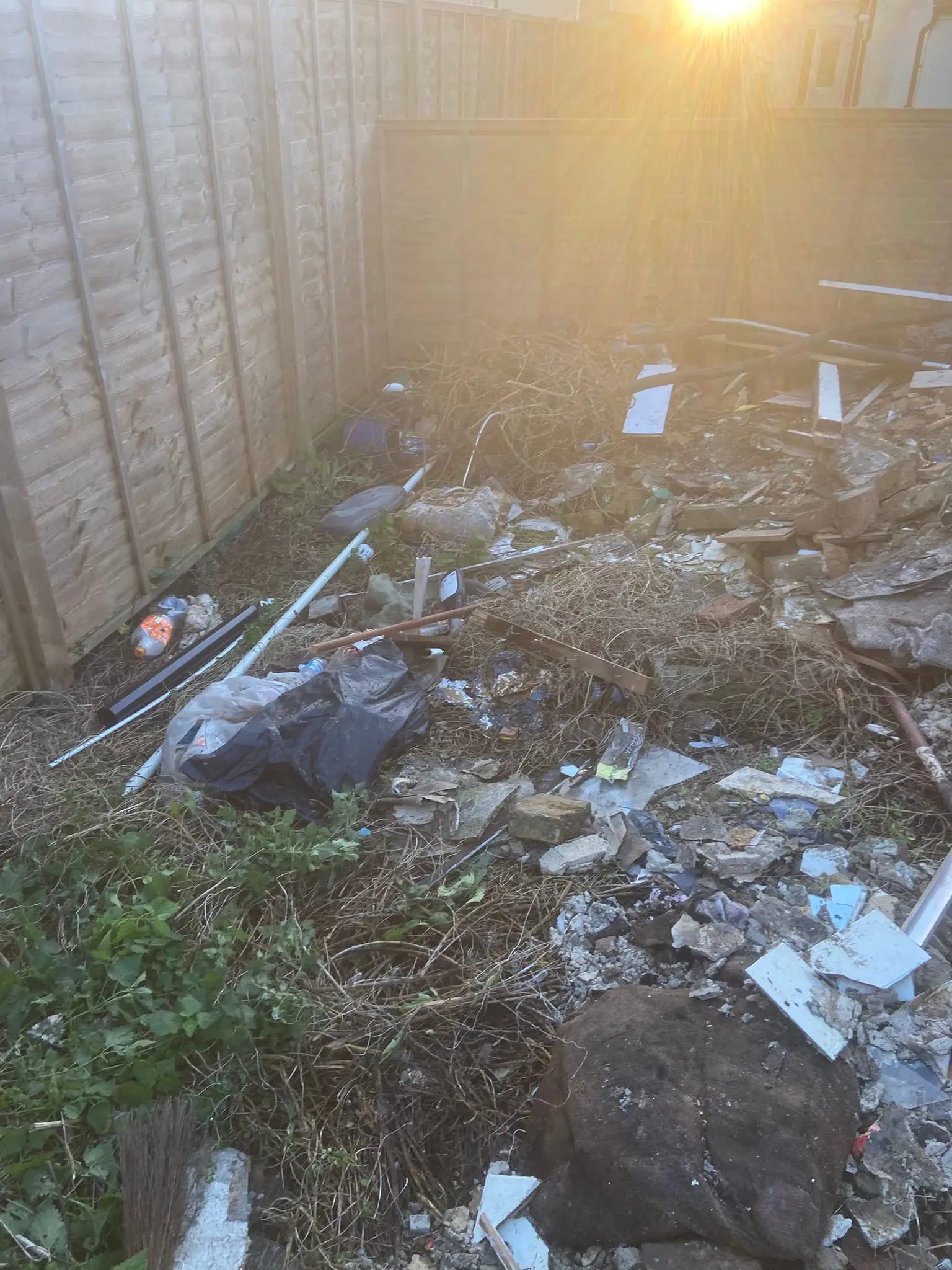 Yard stacked with mixed waste awaiting clearance